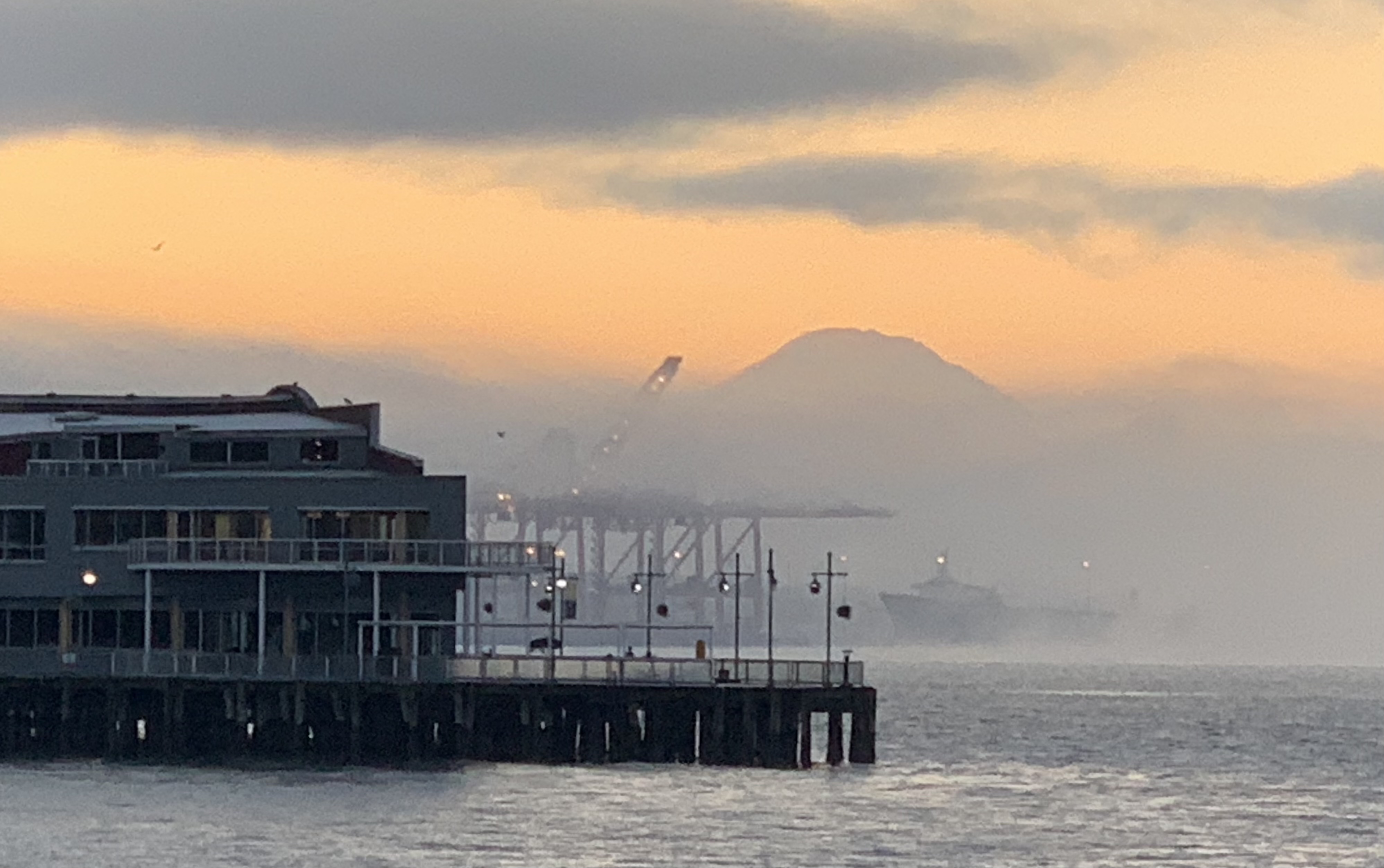 Seattle waterfront pier at sunset with Mt. Rainier in the background